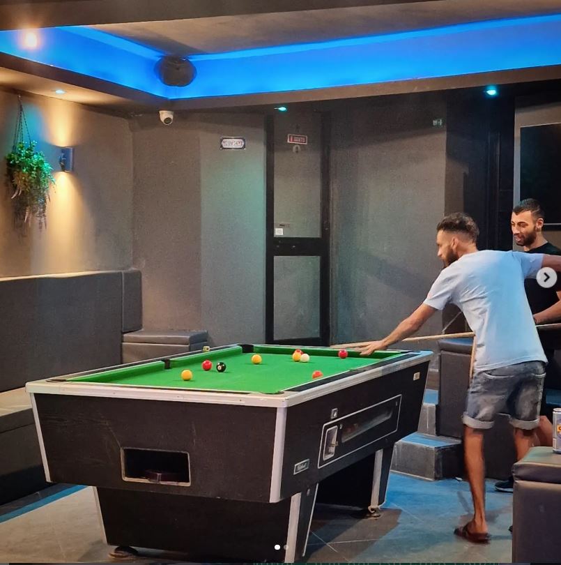 Friends playing pool at Tipsy 303 in Rabat
